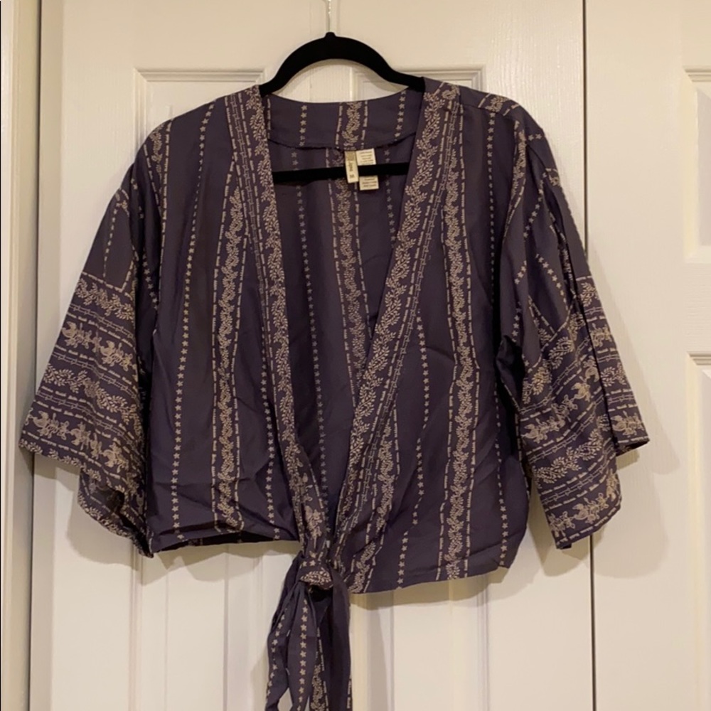 Never been worn. Blue blouse with tie
